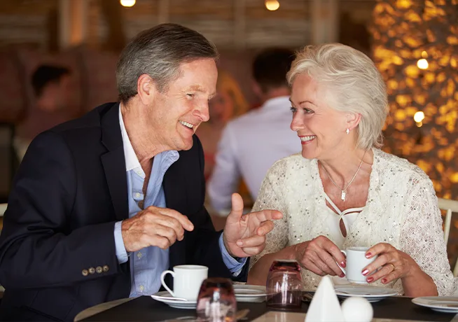 retired happy couple at restaurant for retirement seminars