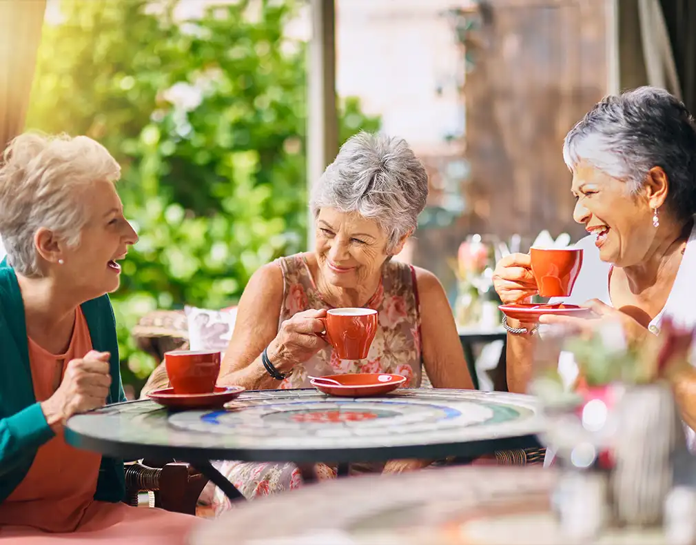senior women at outdoor restaurant laughing together will you have enough to retire